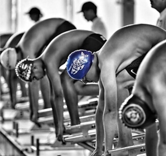 Boundary Bay Bluebacks swimmers flexing and laughing together on the pool deck